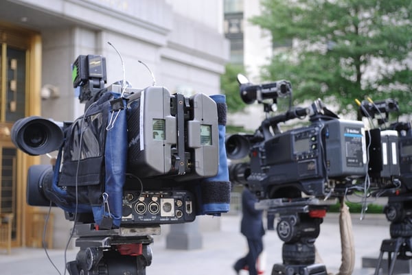 video cameras poised outside of a courthouse